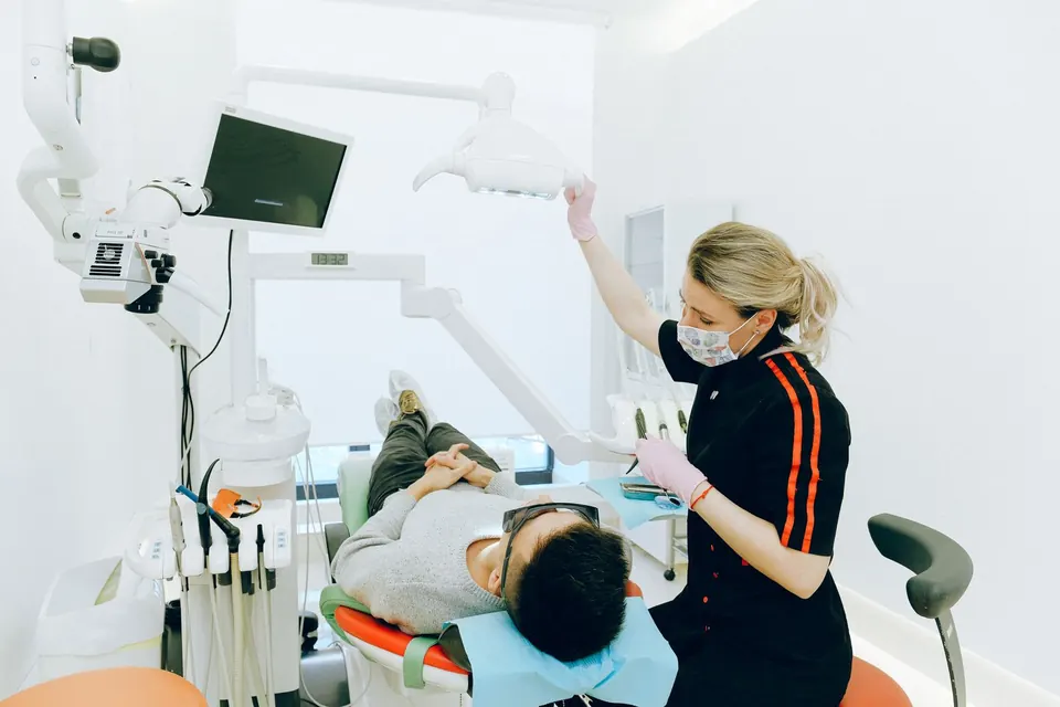 Dentist working with a patient in a bright, modern dental treatment room